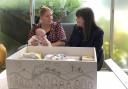 Children's minister Clare Haughey (right) meets the recipient of one baby box