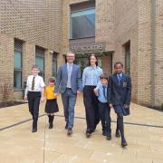 Gerard Curley, headteacher of Neilston Primary and Madras Family Centre, and Marie Kane, headteacher of St Thomas’ Primary with pupils outside the new campus