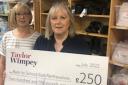 Sheena Hutton (left) and Sandra Douglas, of Back to SchoolBank East Renfrewshire, with the cheque from Taylor Wimpey West Scotland