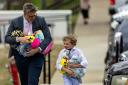 A man and young boy carrying plush toys leave the funeral service for Covenant School shooting victim Evelyn Dieckhaus (Wade Payne/AP)