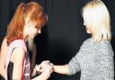 Dancer Lauren gives pop star Kimberly Wyatt one of her homemade bracelets