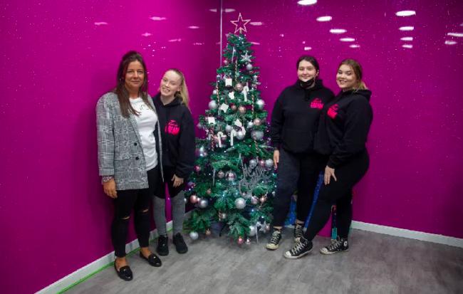 Jennifer Cairns (left), of Ice & Cream, with other members of staff at the Christmas tag tree