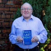 William Brown proudly holding his 'Twice Last Night' book
