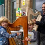 Neil Wood with a couple of budding musicians at a come and try event outside The Bank last year