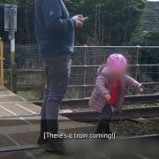 Network Rail have released the shocking CCTV footage as a warning to parents about the dangers of letting their children play on railway crossings