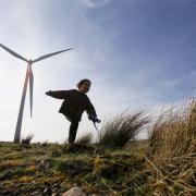 A young child plays among the wind turbines at Whitelee windfarm on Eaglesham moor. The windfarm is the largest in Europe.

Photograph by Colin Mearns
22 March 2012